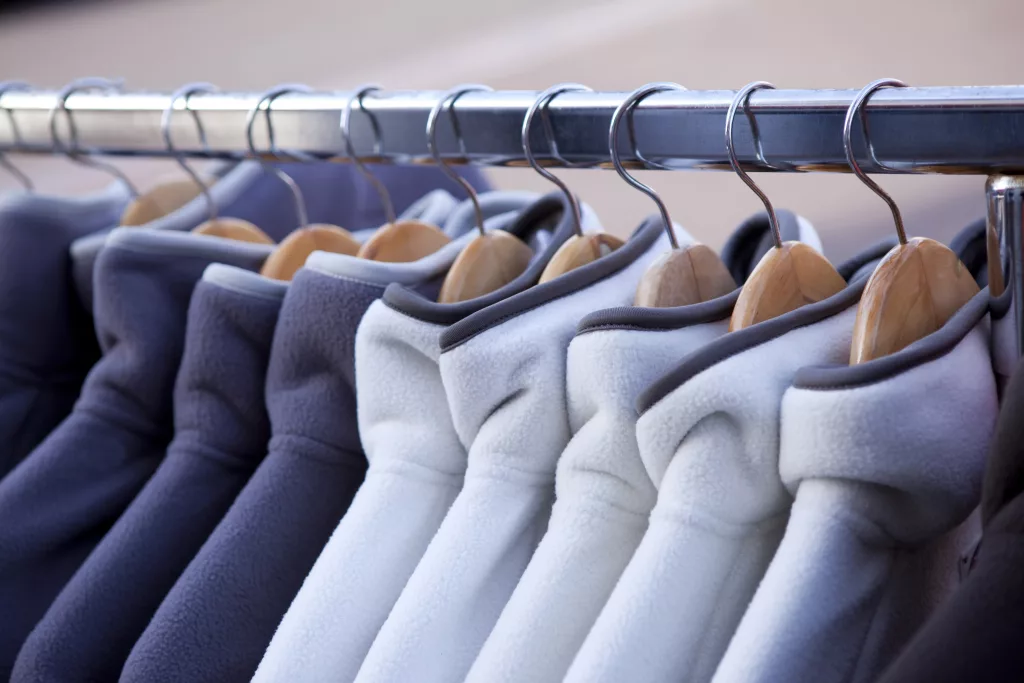 Fleece jackets hanging on coat hangers in a fashion store