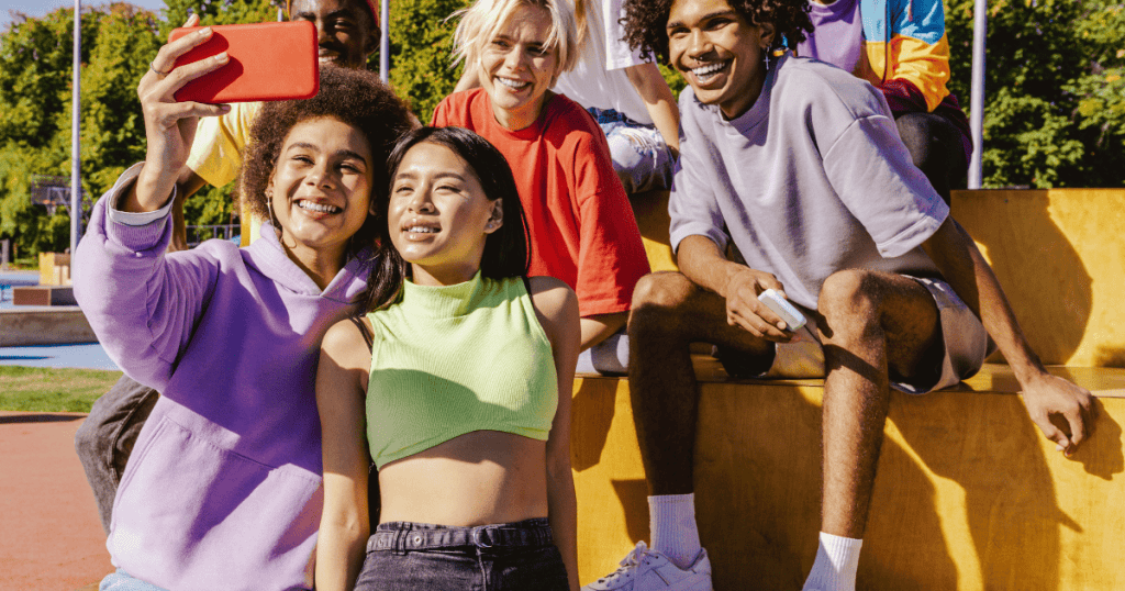 multiracial group of Gen Z youth posing for social media pictures with their recycled, reused and circular fashion trends.